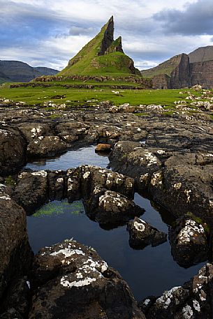 Tindhólmur is an islet on the southside of Sørvágsfjørður, west of Vágar in the Faroe Islands, Denmark, Europe Tindhólmur is an islet on the southside of Sørvágsfjørður, west of Vágar in the Faroe Islands, Denmark, Europe